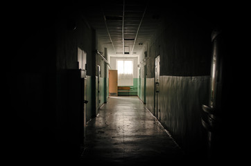 Sinister dark corridor and day lights in the window in the end.  Light at the end of the way...