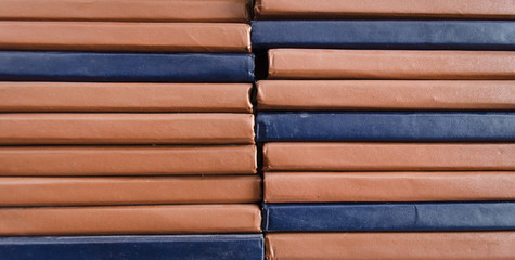 Stacked old books on a bookshelf in the library , close up background. Front view. Education concept.