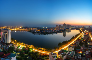 Fototapeta na wymiar Aerial view of Hanoi skyline cityscape at twilight period. Linh Dam lake, south of Hanoi capital