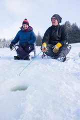 Fototapeta na wymiar Couple ice fishing