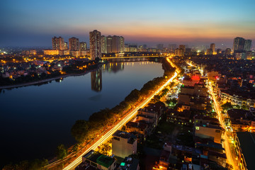 Fototapeta na wymiar Aerial view of Hanoi skyline cityscape at twilight period. Linh Dam lake, south of Hanoi capital
