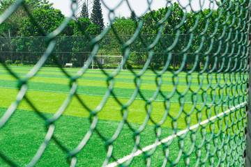 a soccer field behind the fence