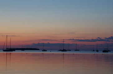 Fototapeta na wymiar Sunset over lake with sail boats