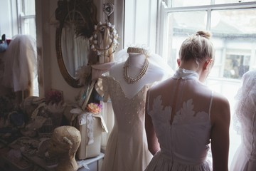 Rear view of young bride in white wedding dress