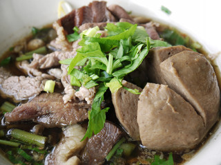 Vegetable noodle with stewed pork on wood table