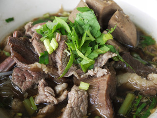 Vegetable noodle with stewed pork on wood table