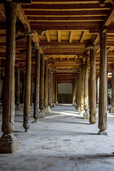 Fototapeta na wymiar Carved wooden pillars in madrassa, Khiva