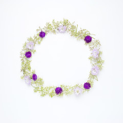 round frame wreath pattern with Globe Amaranth, blue cutter and wild ﬂowers on white background. flat lay, top view
