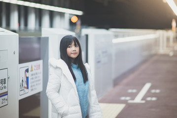 Asian girl waiting for train