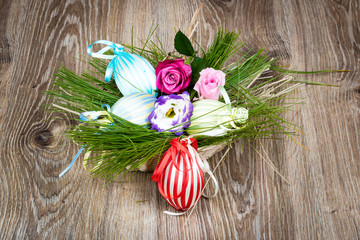 Easter eggs with flowers on wooden background. Toned image