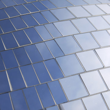 Modern glass building reflection blue sky