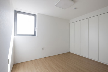 white empty room with window, wood floor