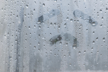 Natural water drop on glass with sadly face hand draw