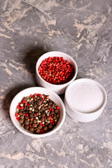 assortment of pepper and salt in bowls, closeup, vertical