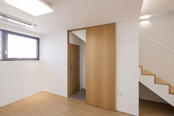 empty white room with wood door.