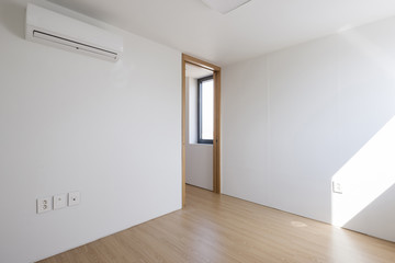 empty white room with wood door.
