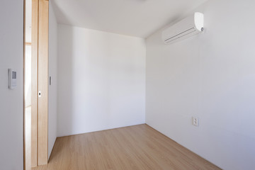 empty white room with wood door.