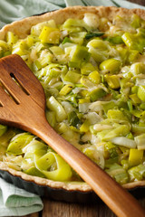 freshly baked savory leek pie with cheese close-up. vertical