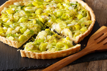 Sliced tart with leek and cheese close-up. horizontal
