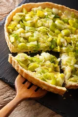  Sliced tart with leek and cheese close-up. vertical © FomaA