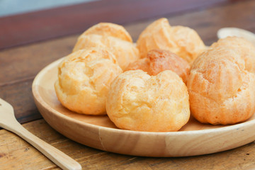 Choux cream served in wooden dish 