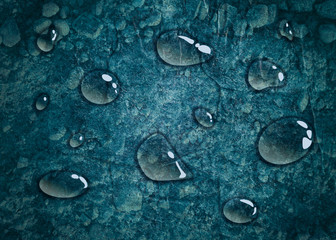 Transparent water drops on blue background. Concrete Wall Textured Backdrop Surface