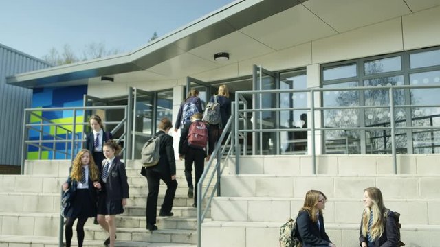  Young children walking into school building at the beginning of the day