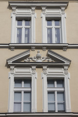 Four vintage design windows on the facade of the old house