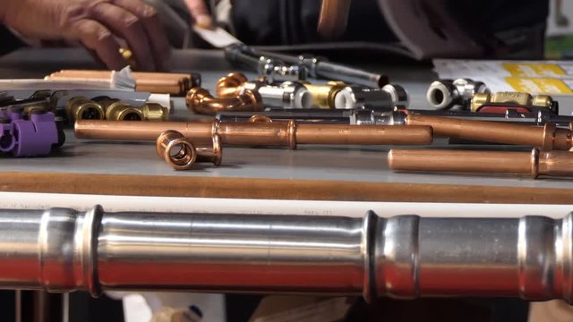 People, plumbers are checking plumbing pipe fittings samples