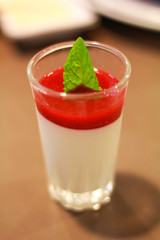 delicious dessert panna cotta in a glass and fresh strawberries