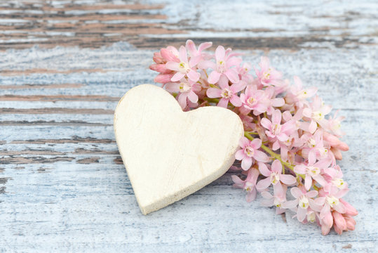 heart and flower lying on wood