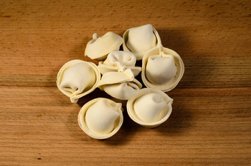 Heap of the frozen dumplings on wooden table