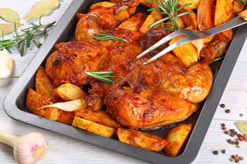 chicken on baking tray with potato wedges
