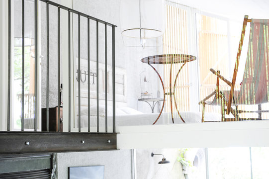 White bedroom, table and chaise longue for a relaxing night