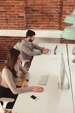 Businessman and his colleague working at desk