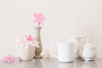 pink flowers and cup of tea on white background
