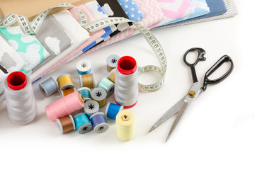 Fototapeta na wymiar cotton fabric, tailor measurement tape and spools of cotton thread