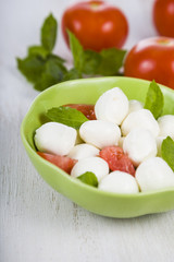 Caprese salad on a wooden table.