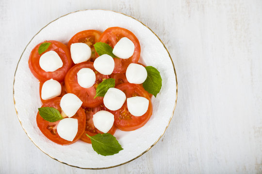 Caprese salad on a wooden table.