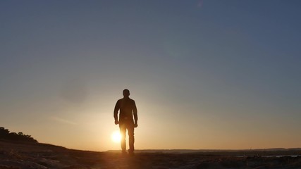 travel. Man is walking at sunset silhouette journey travel lifestyle