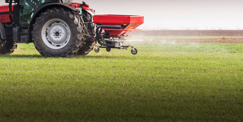 Tractor spreading artificial fertilizers