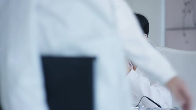  Electronics engineers working in the lab with manager overseeing