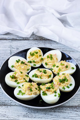 Home eggs stuffed with cheese and crab topped with green onions