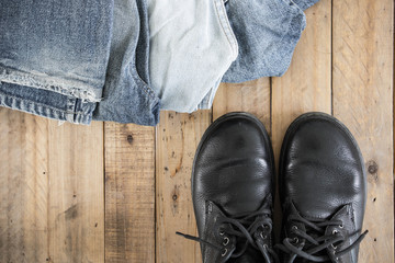 Jeans and shoes on wooden floor