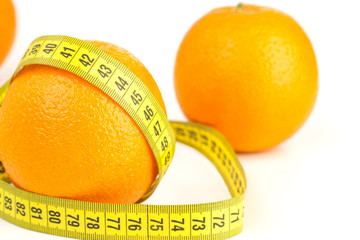 ripe oranges and tape measure