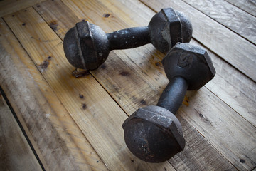 The old dumbbell on the wooden floor.