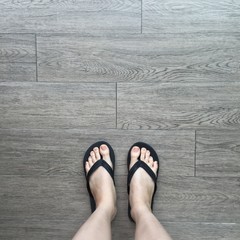 Young Girl Legs in Black Sandals on Wood Floor Great For Any Use.