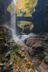 Fototapeta na wymiar Beautiful waterfall cascade at Watkins Glenn state park, with autumn foliage colors
