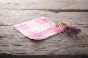 pink napery with dry flowers on wood table.
