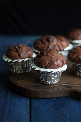 Homemade chocolate muffins on a dark wooden table tablebackground. Copy space. Mini cakes with chocolate